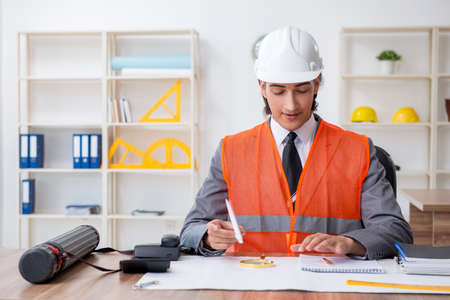Young male architect working in the office