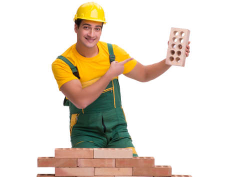 The handsome construction worker building brick wallの写真素材