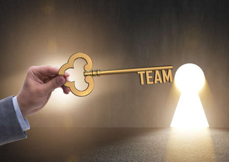 Businessman with key in teamwork conceptの写真素材