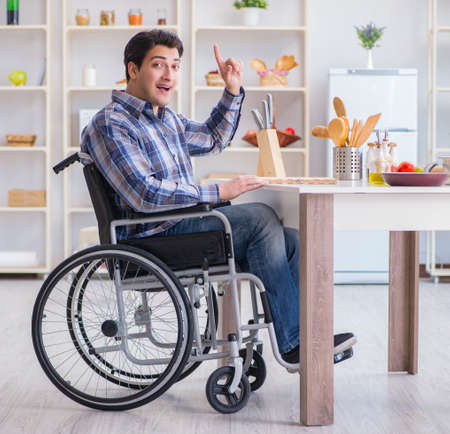 Disabled young man husband working in kitchenの写真素材