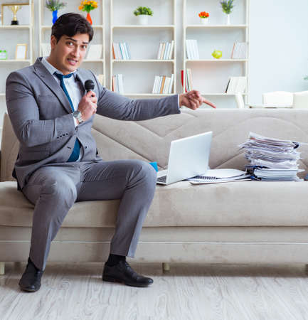 Sad businessman singing in officeの写真素材