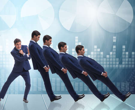 Businessman in domino effect business conceptの写真素材