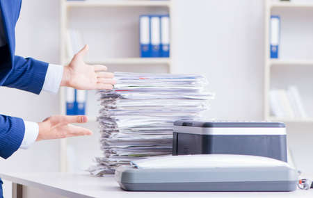 Businessman making copies in copying machineの写真素材