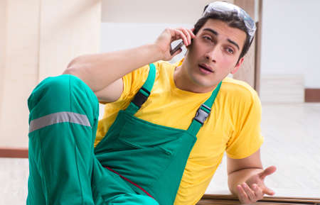 Contractor working on laminate wooden floorの写真素材