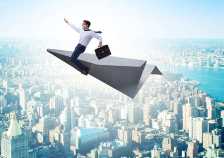 Businessman flying on paper plane in business concept