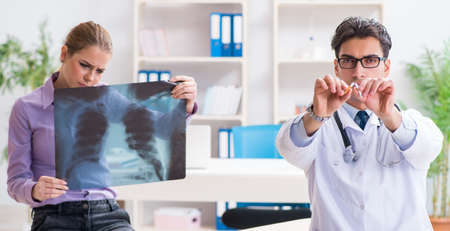 Doctor examining x-ray images of patientの写真素材
