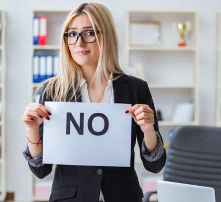 Young businesswoman with message in the officeの写真素材