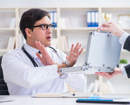 Young doctor in medical insurance fraud conceptの写真素材