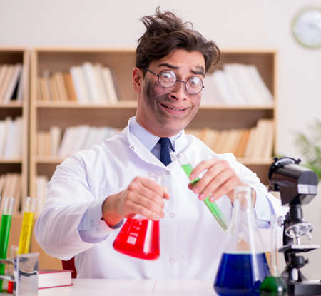 Mad crazy scientist doctor doing experiments in a laboratoryの写真素材