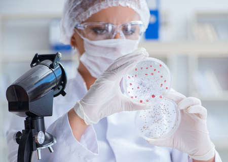 Female scientist researcher conducting an experiment in a labora