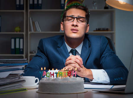Man celebrating birthday in the officeの写真素材