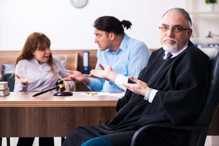 Young couple in the courthouse in divorce conceptの写真素材