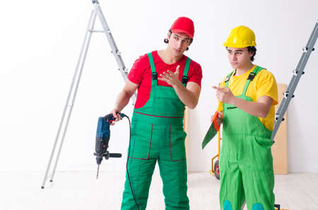 Two workers contractors working indoors