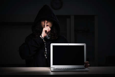 Female hacker hacking security firewall late in office