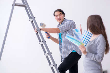 Young family doing renovation at homeの写真素材