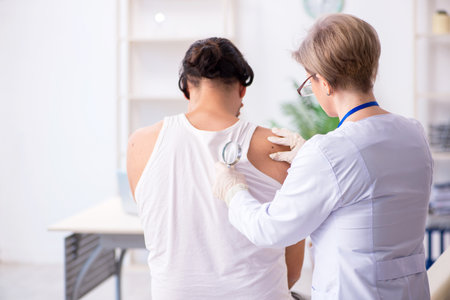 Young patient visiting doctor in hospitalの写真素材