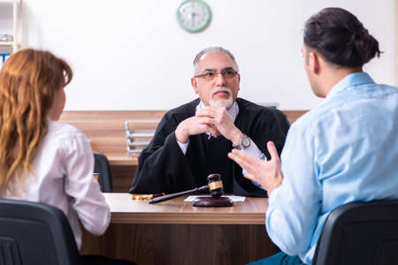 Young couple in the courthouse in divorce conceptの写真素材