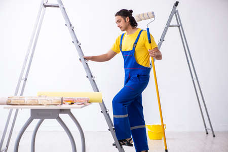 Young man contractor doing renovation at homeの写真素材