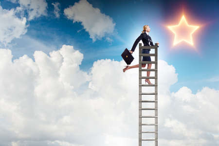 Businesswoman reaching out for stars in success concept