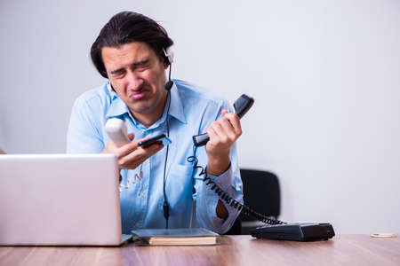 Call center operator working at his deskの写真素材