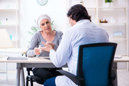 Young male doctor and female oncology patientの写真素材