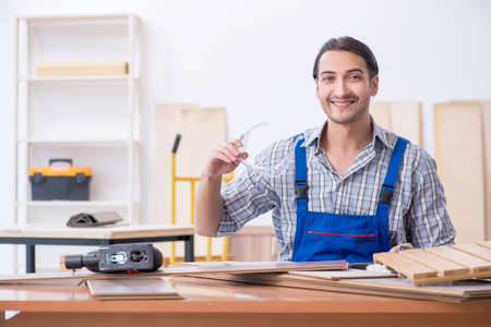 Young male carpenter working indoorsの写真素材