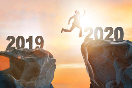 Businessman jumping from year 2019 to 2020の写真素材