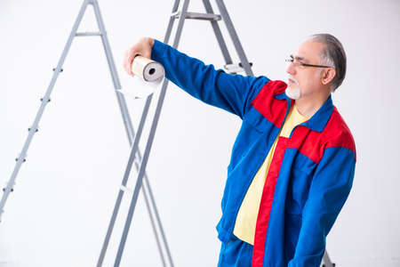 Old contractor doing renovation at homeの写真素材