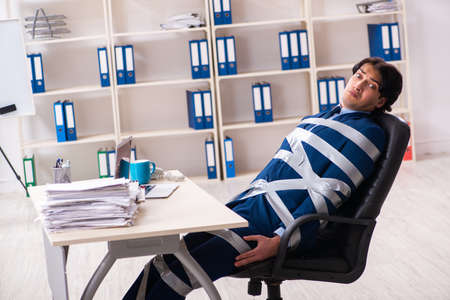 Young tied male employee in the officeの写真素材