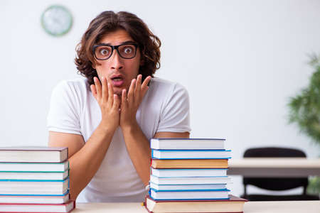 Young male student sitting in the classroomの写真素材
