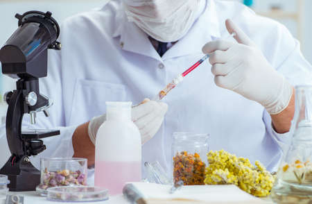 Chemist mixing perfumes in the labの写真素材