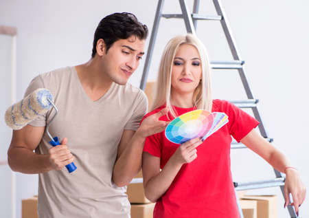 Young family doing painting job during home renovationの写真素材