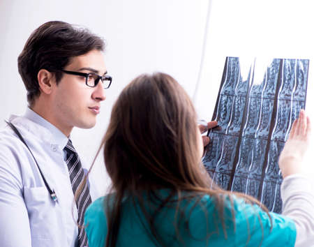 Three doctors discussing scan results of x-ray image