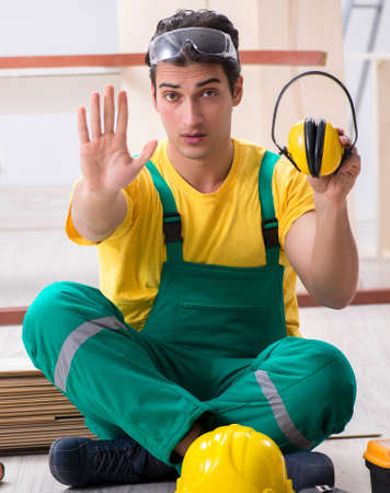 Worker showing the importnace of wearing noise cancelling headphの写真素材