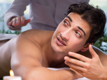 Young handsome man during spa procedureの写真素材