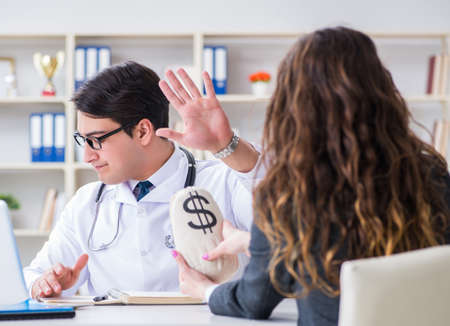 Young doctor in medical insurance fraud conceptの写真素材