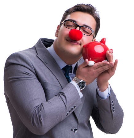 Funny clown businessman with a piggy bank isolated on white backの写真素材