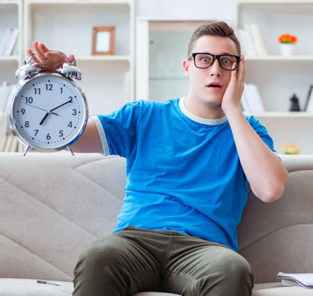 Young student preparing for exams studying at home on a sofaの写真素材