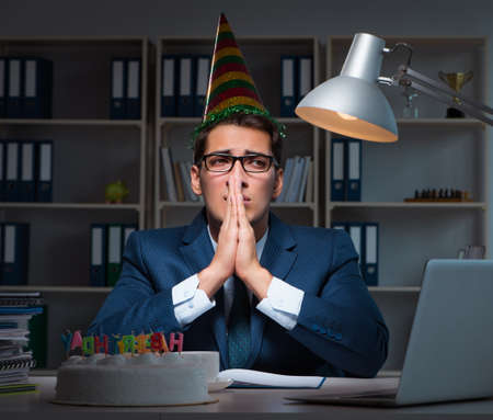 Man celebrating birthday in the officeの写真素材