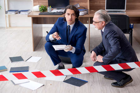 Two experts criminologists working in the officeの写真素材