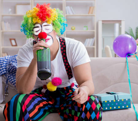 Drunk clown celebrating having a party at homeの写真素材