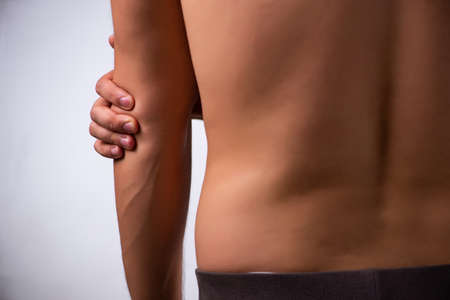 Young man suffering from upper limb pain