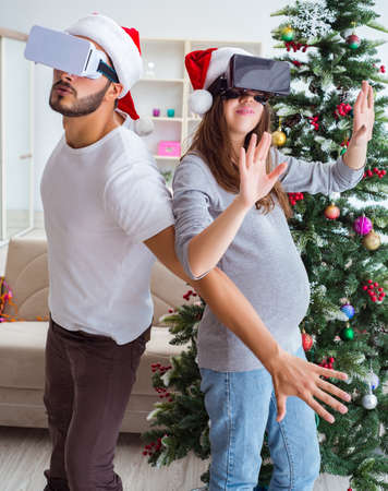 Young family expecting child baby wearing virtual reality VR glaの写真素材