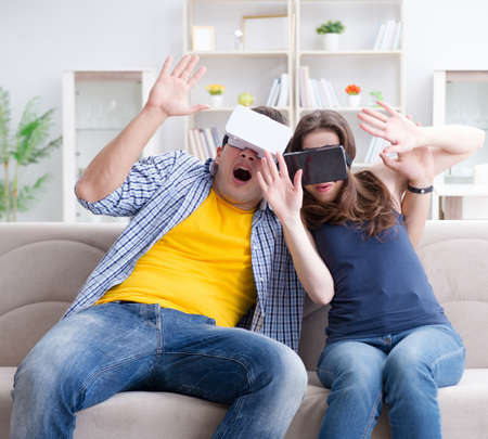 Young family playing games with virtual reality glassesの写真素材