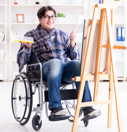 Disabled artist painting picture in studioの写真素材