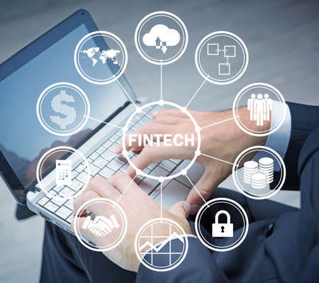Hands working on laptop in financial technology fintech conceptの写真素材