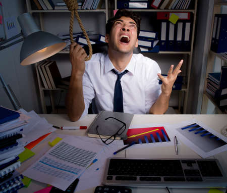 Man businessman working late hours in the office
