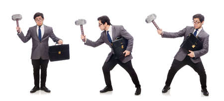 Business man holding hammer isolated on whiteの写真素材