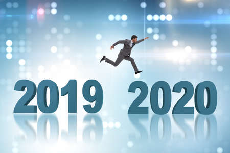 Businessman jumping from year 2019 to 2020の写真素材