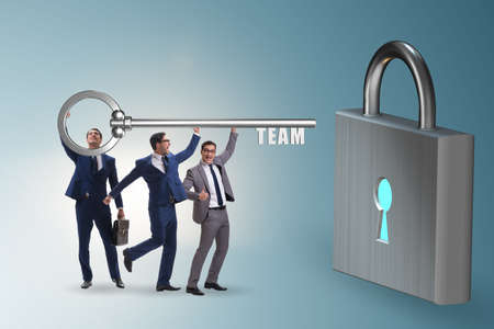 Concept of teamwork with businessmen unlocking lockの写真素材